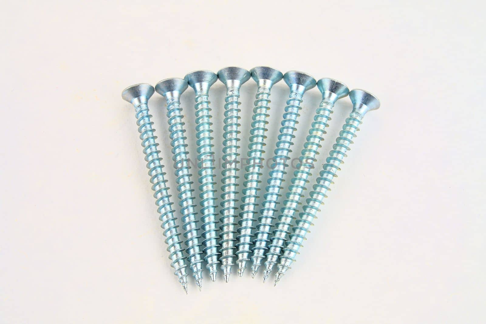 Set of screws for construction on a white background, metal screw, iron screw, chrome screw, screws as a background, wood screw. Close-up.