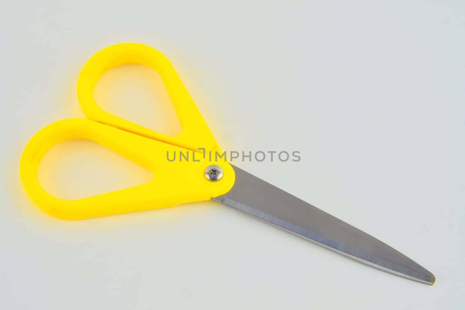 Yellow scissors isolated on a white background. Top view by roman_nerud