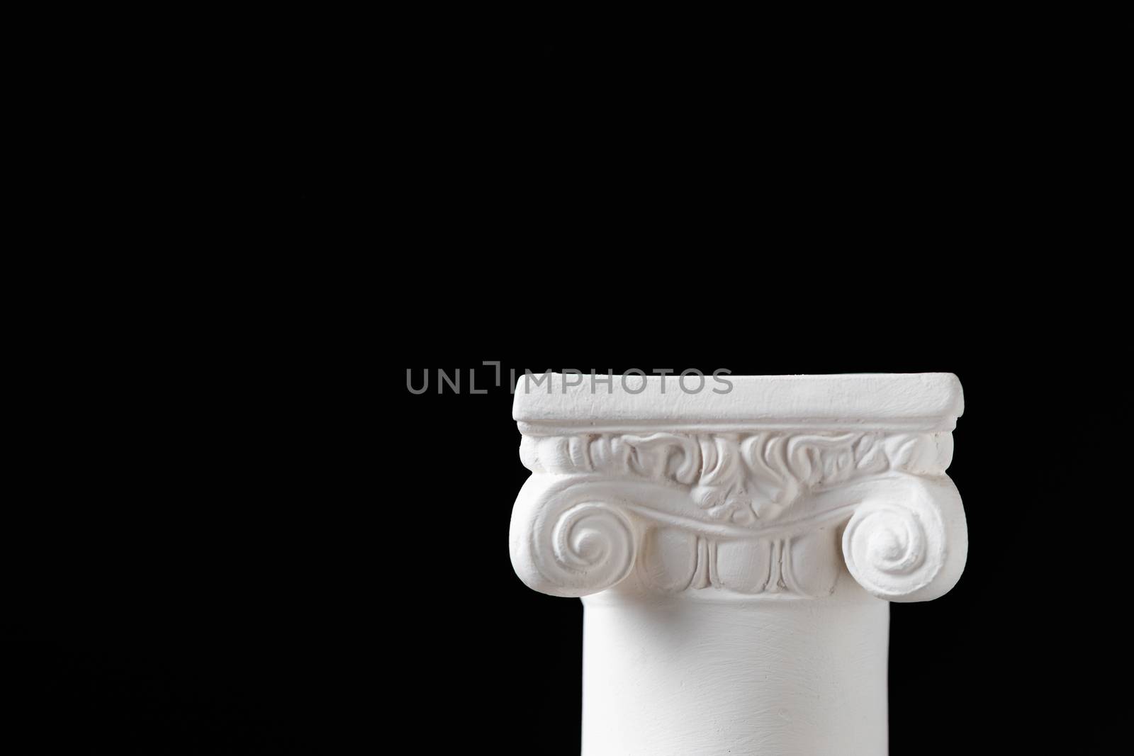 White Ionic Design Column on Dark Background.