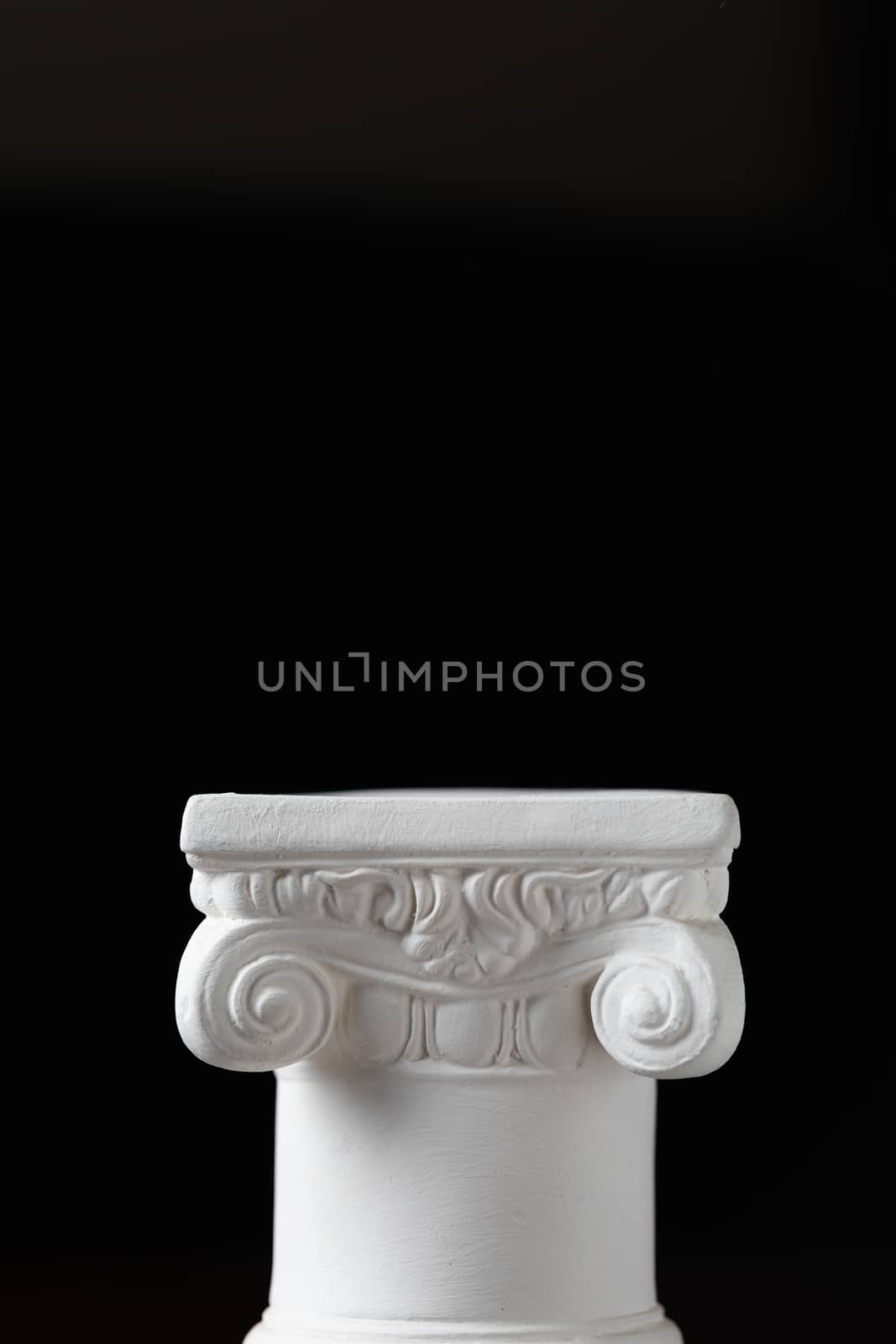 White Ionic Design Column on Dark Background by Feverpitched