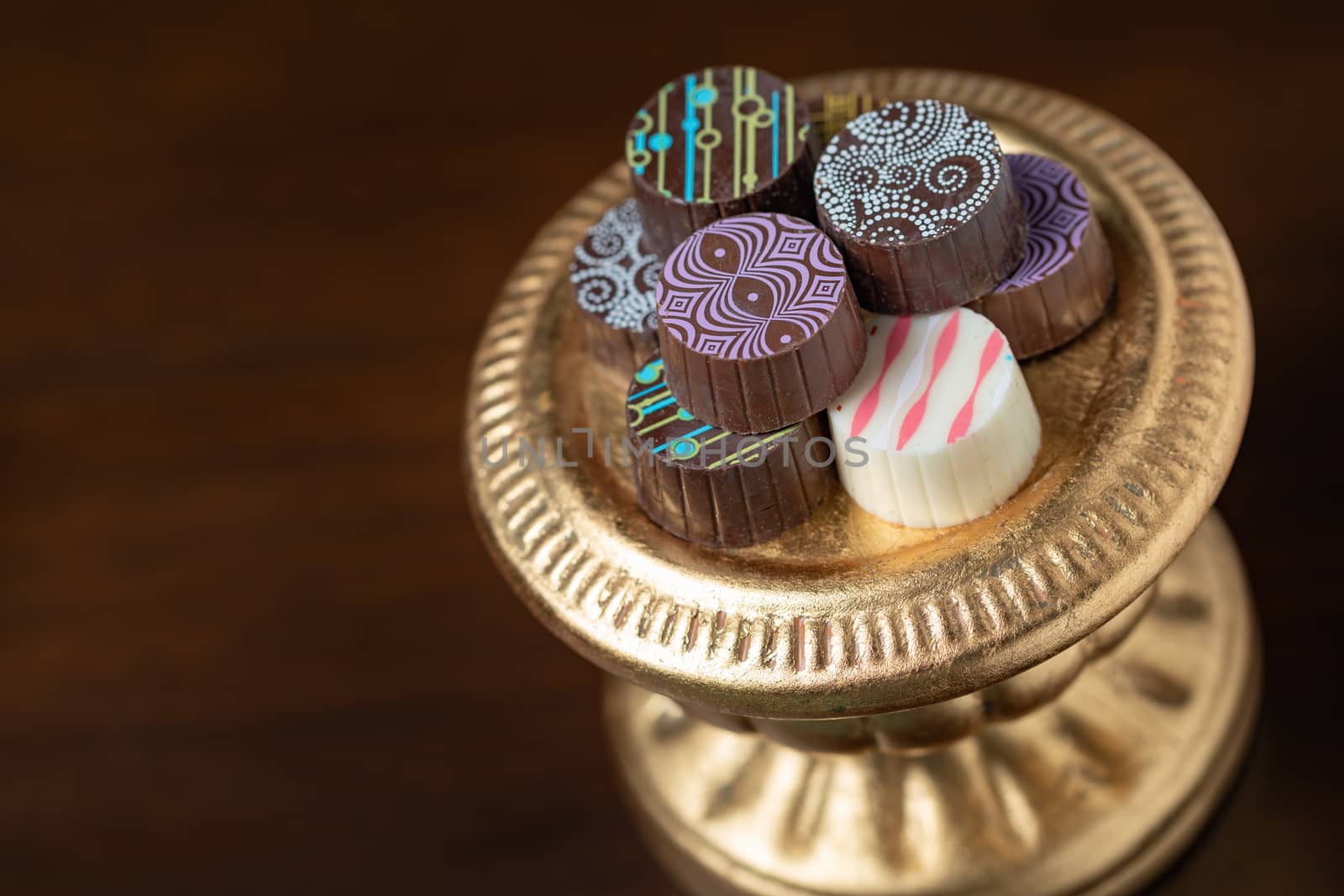 Artisan Fine Chocolate Candy On Gold Pillar Serving Dish.