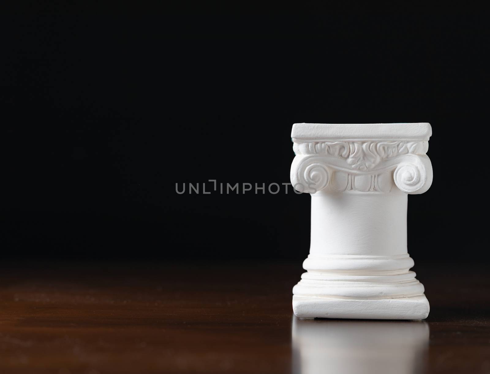 White Ionic Design Column on Dark Background.