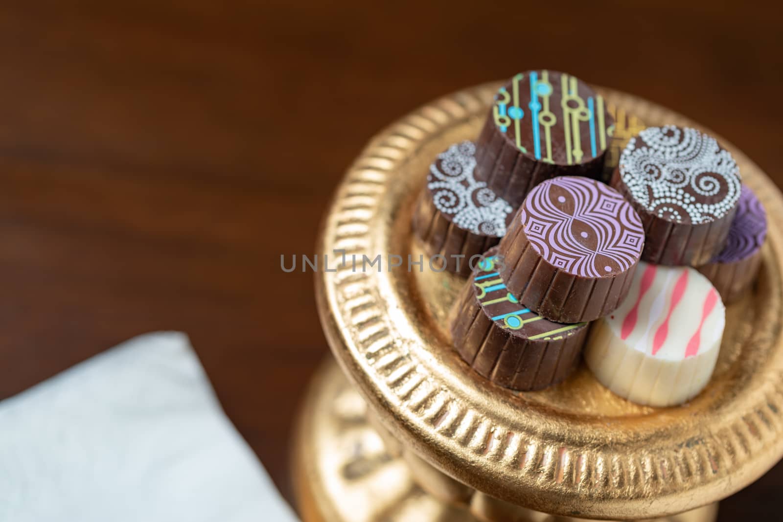 Artisan Fine Chocolate Candy On Gold Pillar Serving Dish.