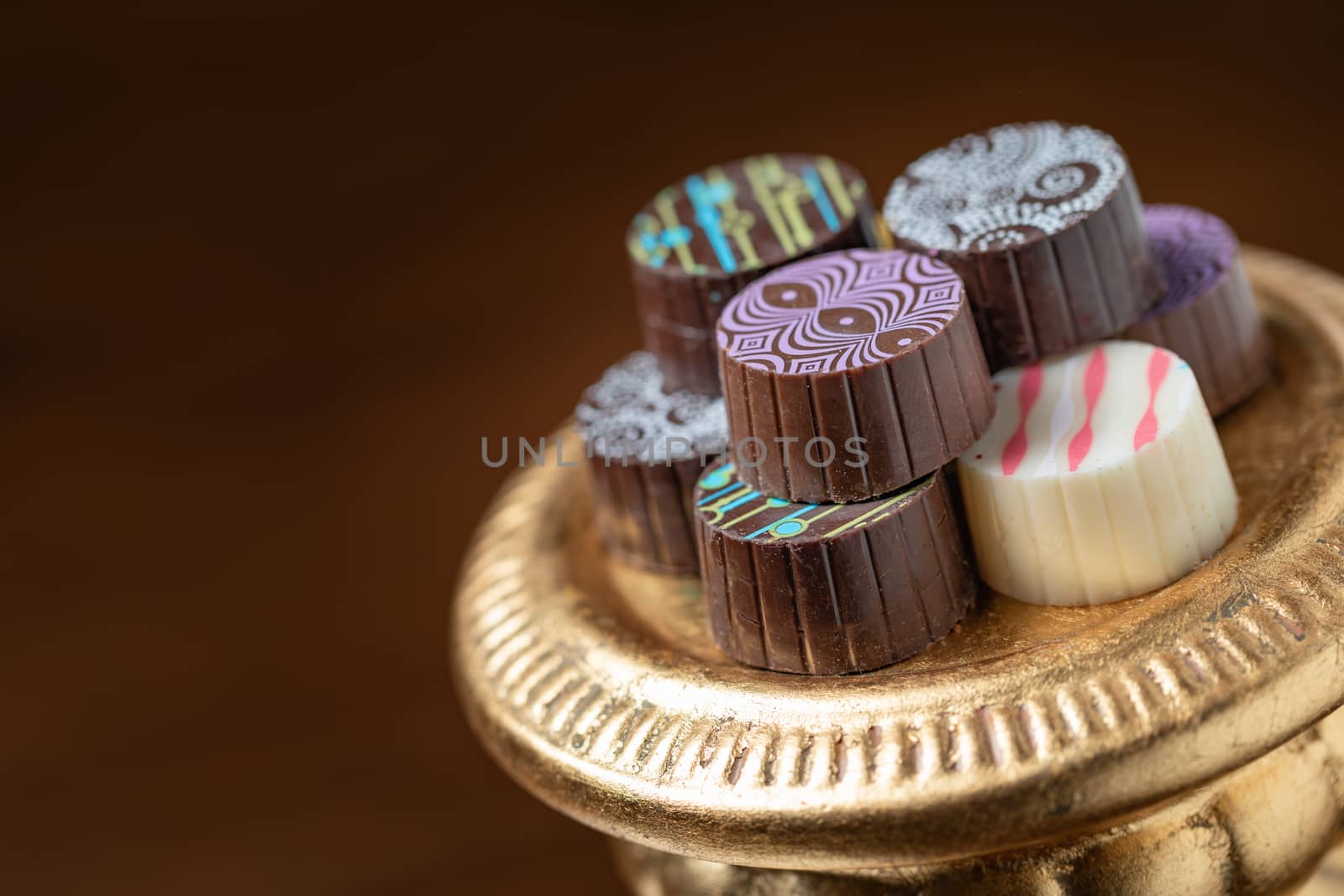 Artisan Fine Chocolate Candy On Gold Pillar Serving Dish.