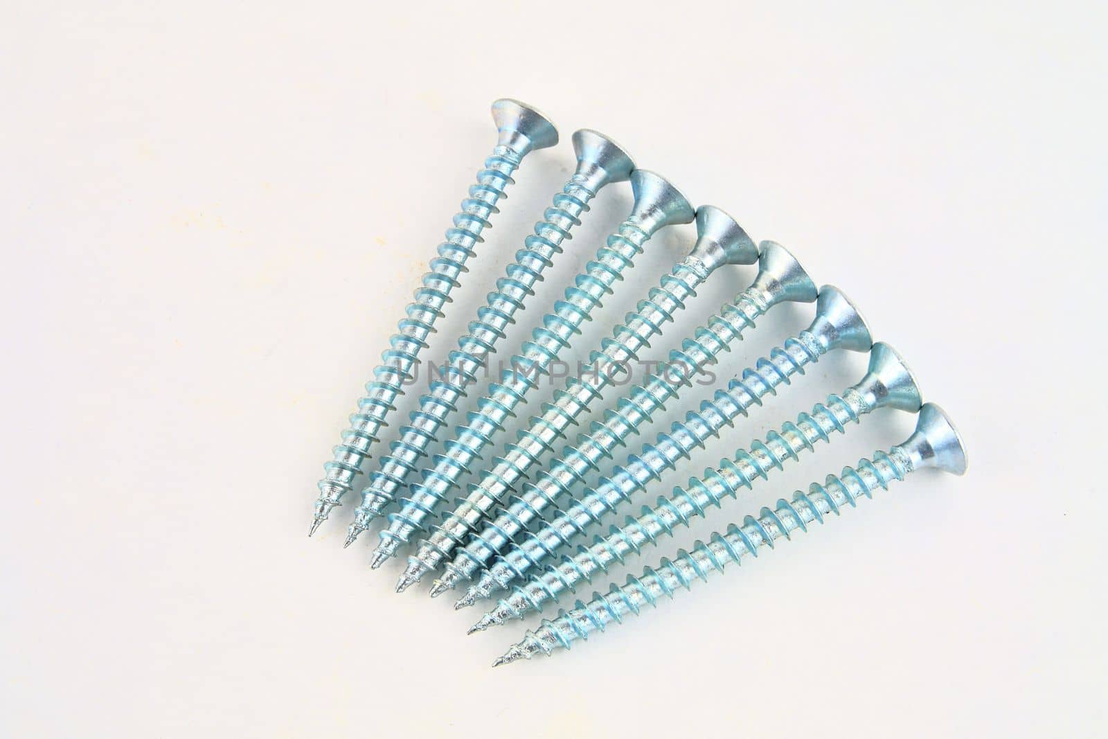 Screws for construction on a white background, metal screw, iron screw, chrome screw, screws as a background, wood screw. Close-up.