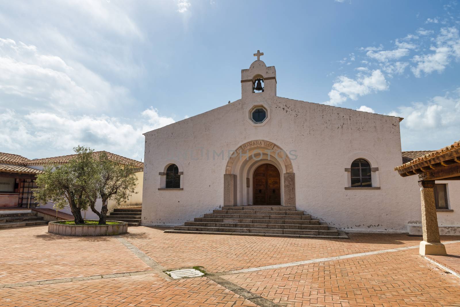 the white holy church in marinella on sardinia island with a square with old architecture