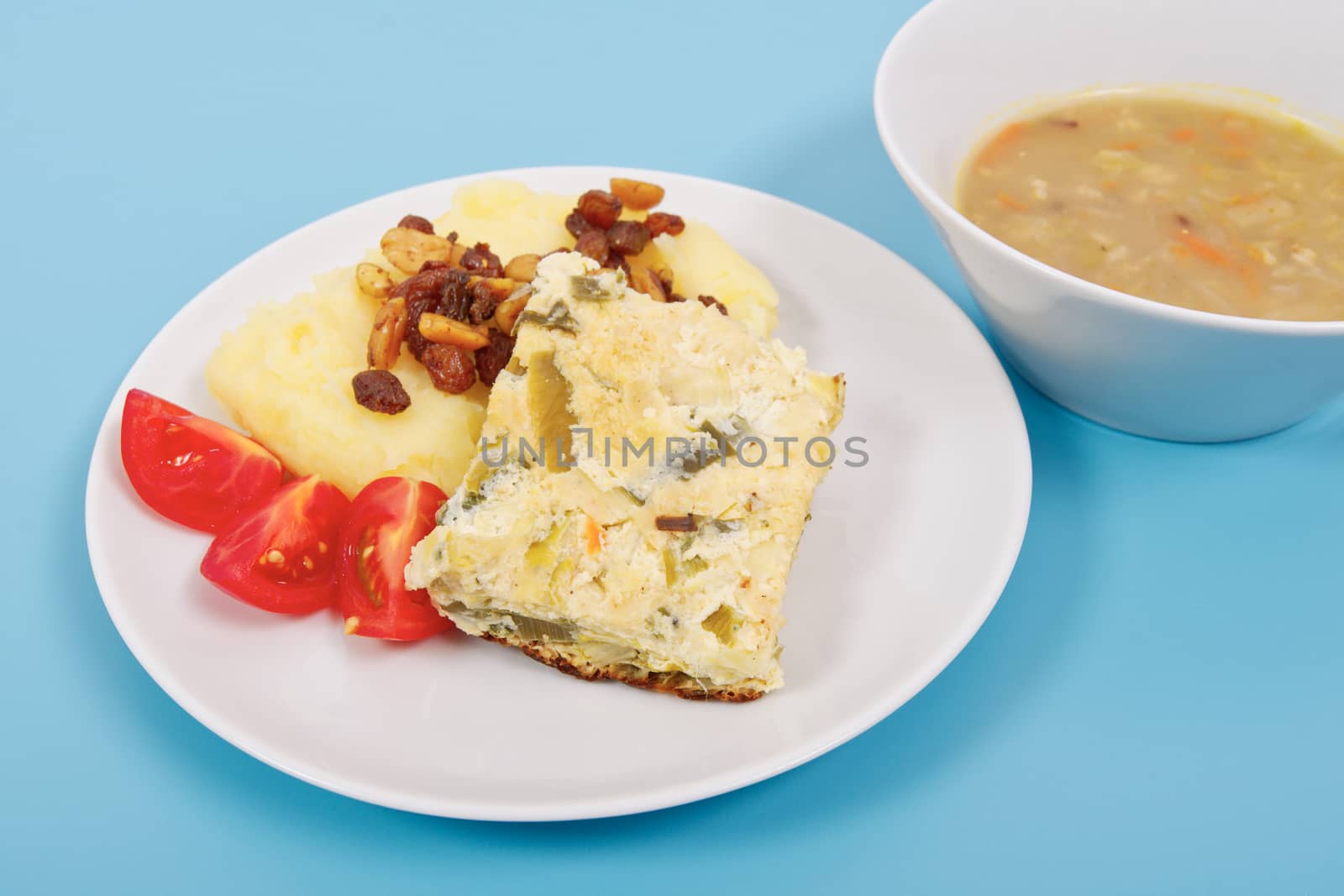 Baked leek with mashed potatoes on a blue background