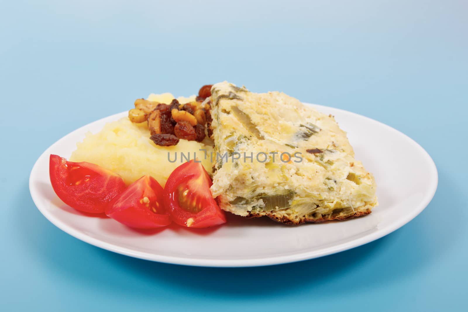 Baked leek with mashed potatoes on a blue background