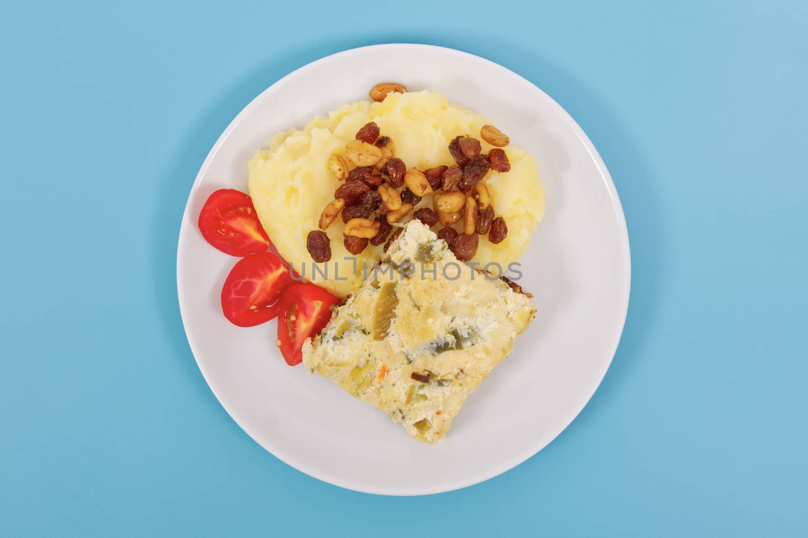 Baked leek with mashed potatoes on a blue background