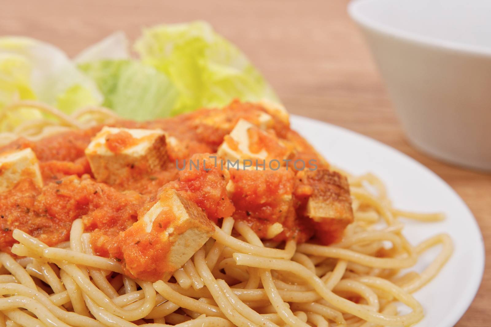 Bolognese spaghetti with tofu on a table by neryx
