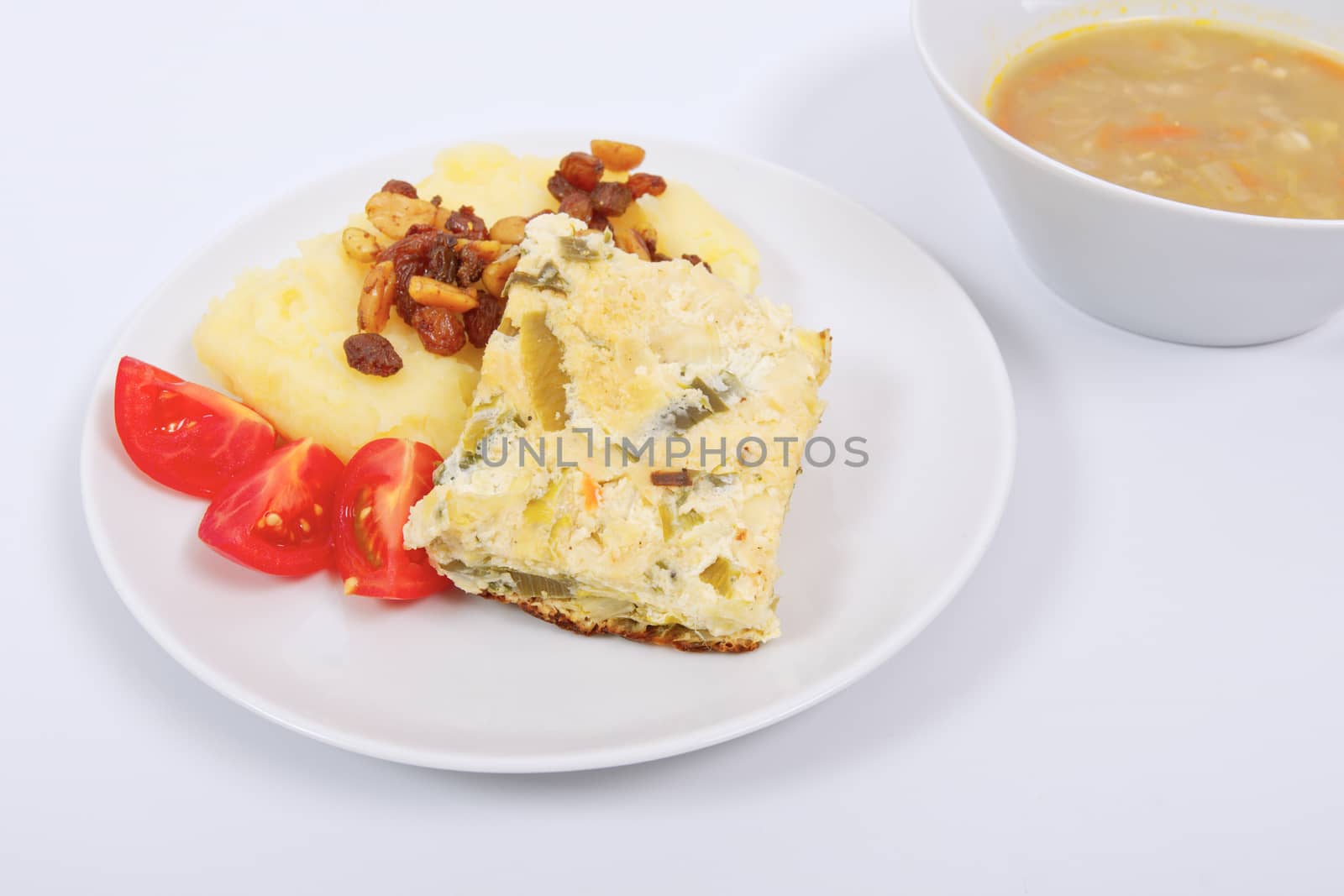 Baked leek with mashed potatoes on a white background