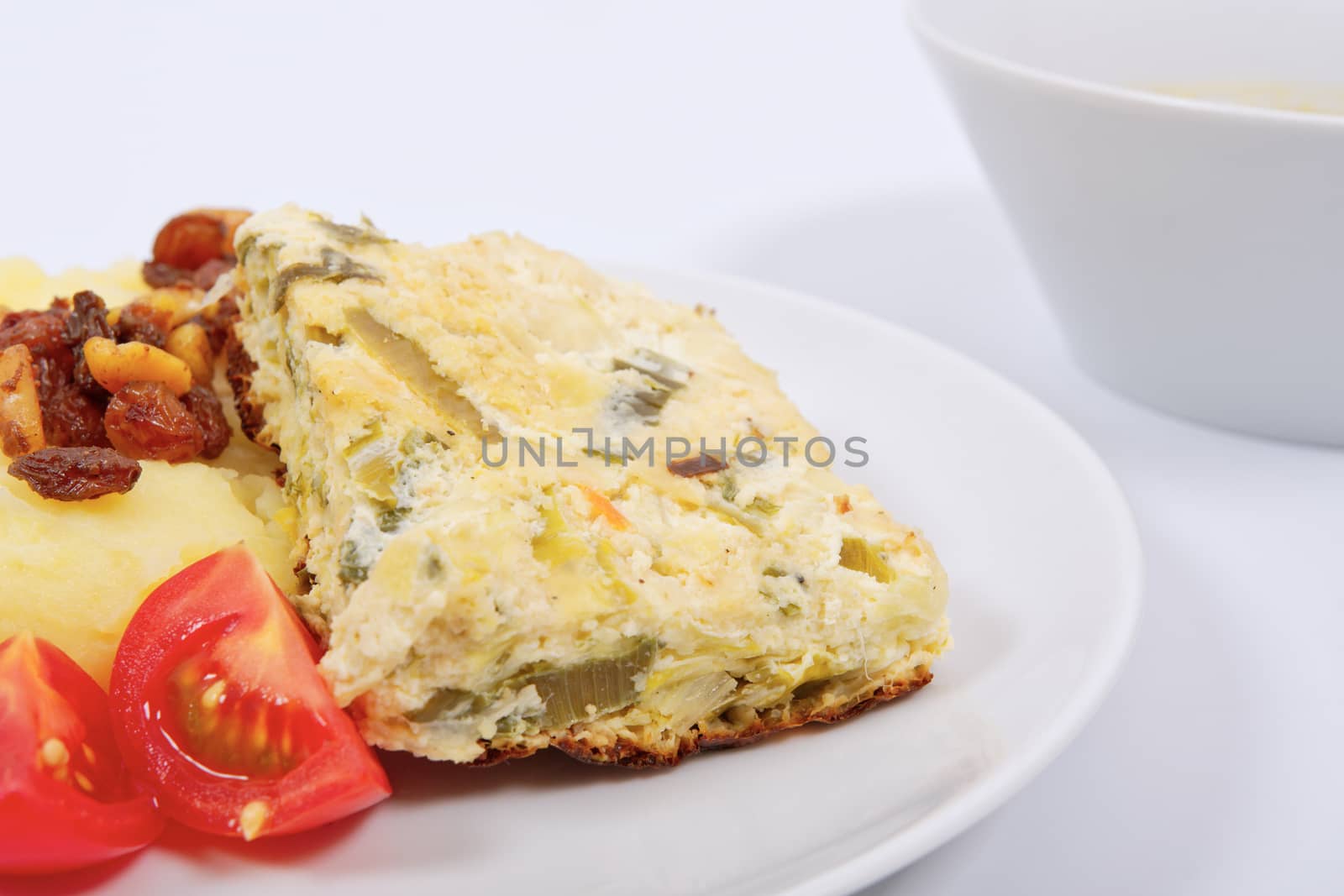 Baked leek with mashed potatoes on a white background