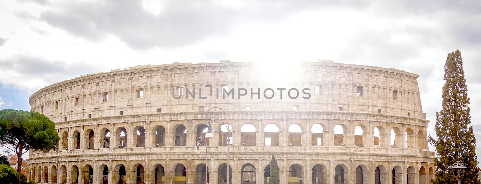 view of the Colosseum in Rome with the sun in backlight