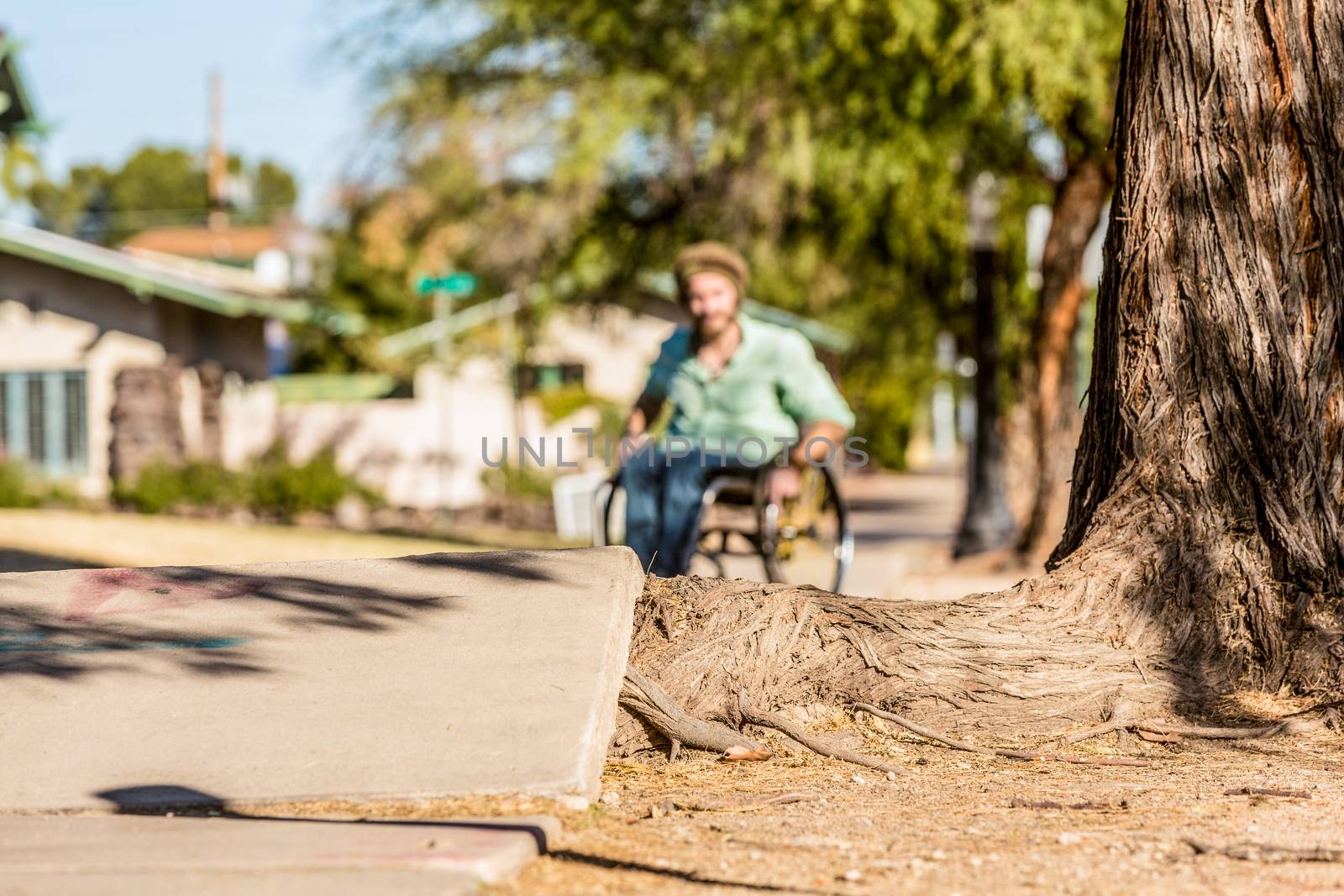 Deep Focus Man in Wheelchair Faces Sidewalk Obstacle by Creatista