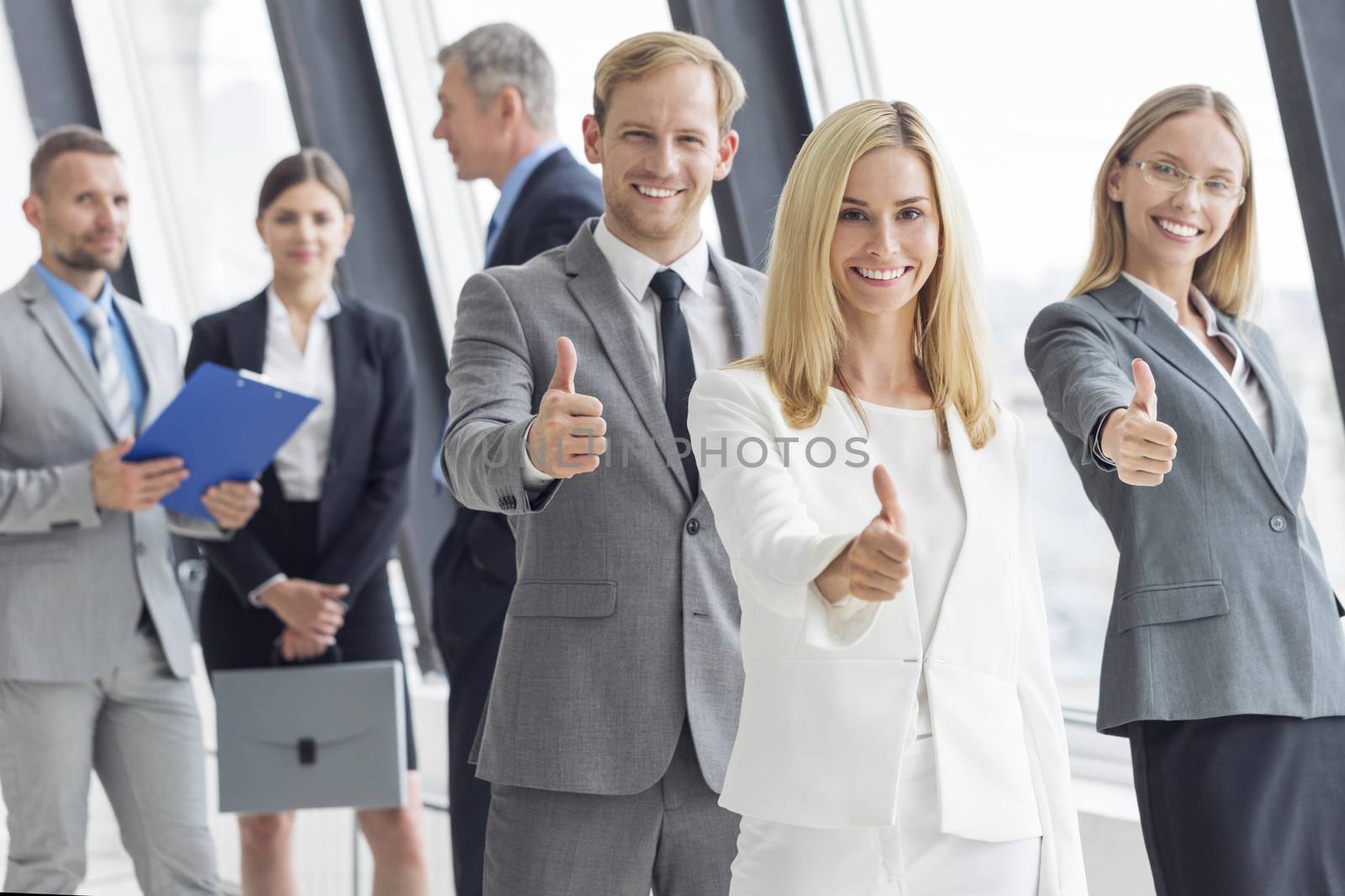 Business people showing thumbs up by Yellowj