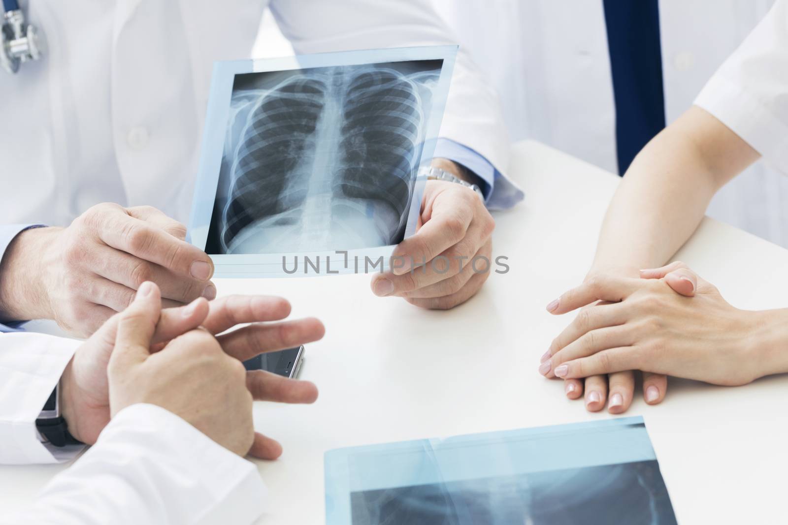 Group of doctors look and discuss x-ray in a clinic or hospital