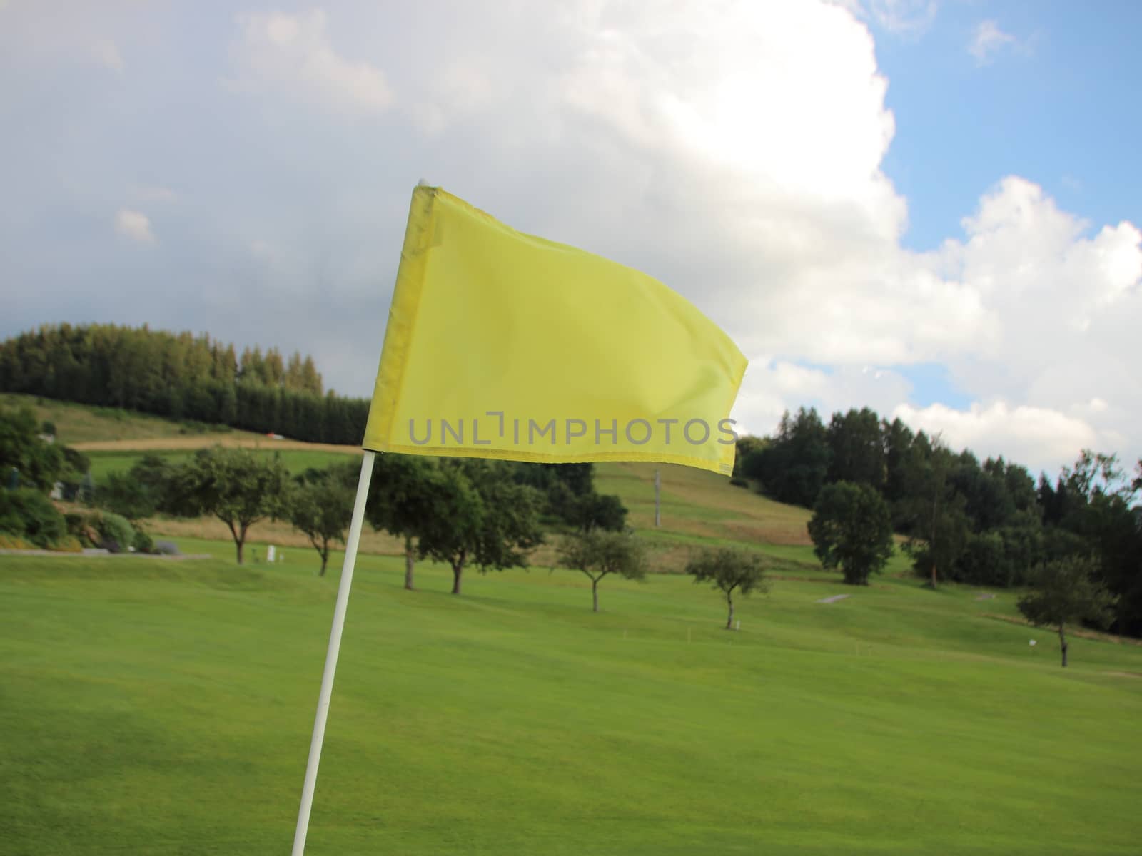 Yellow Windy Flag at Golf Course on Mountain by HoleInTheBox
