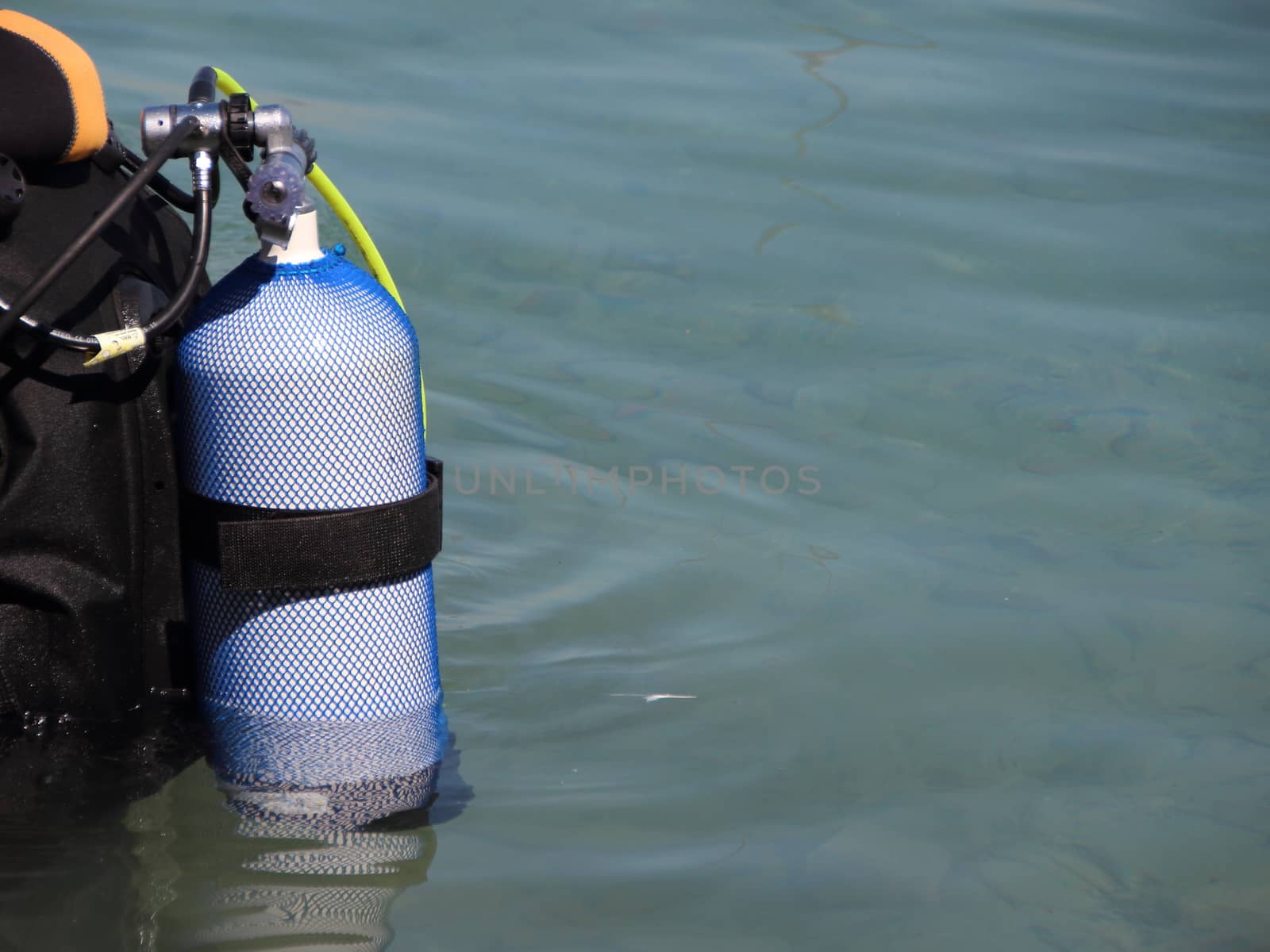 Scuba diving equipment on backside of Diver in Water by HoleInTheBox