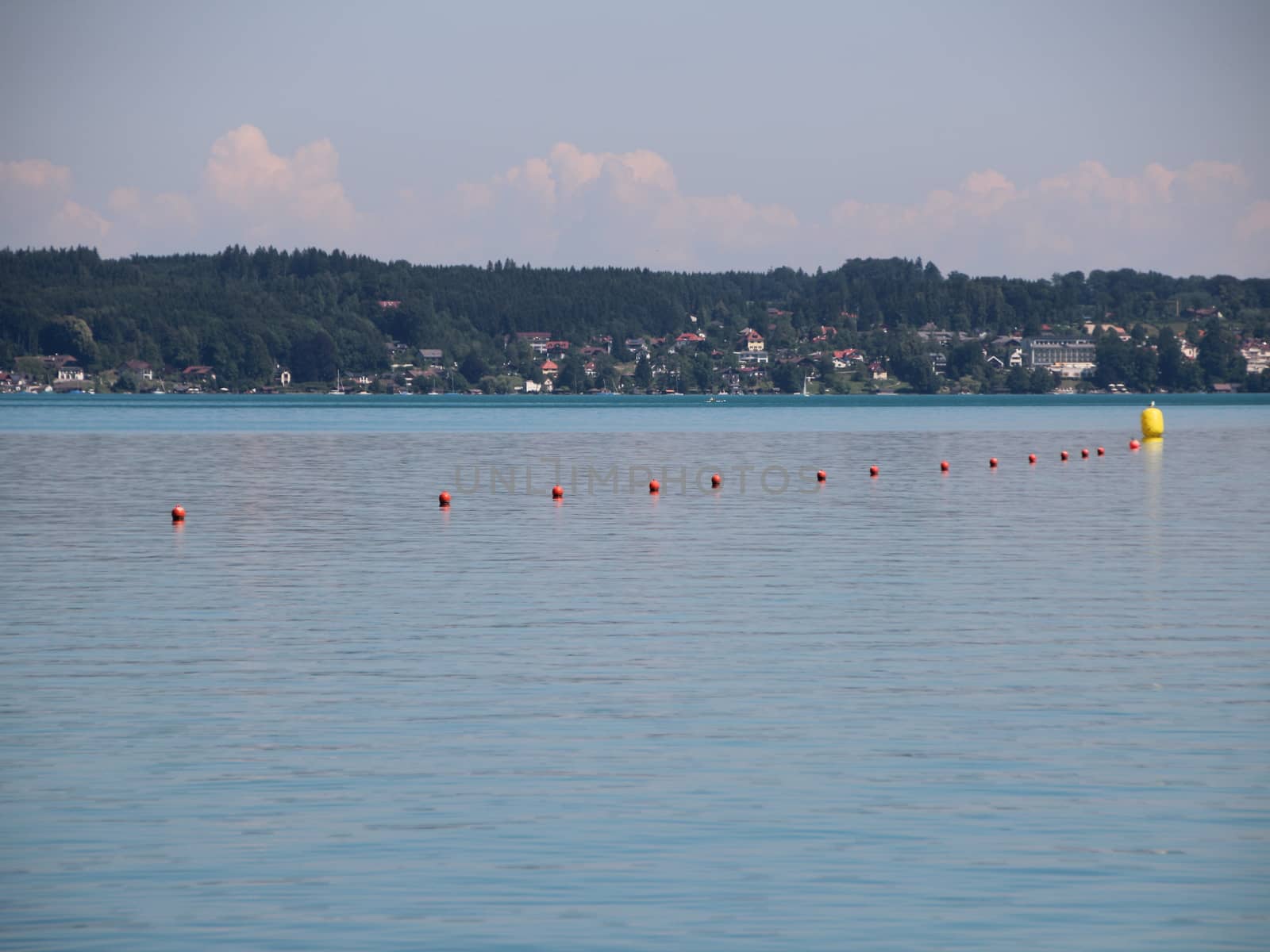 Line of Red Water Markers with One Big Yellow on Blue Lake with background
