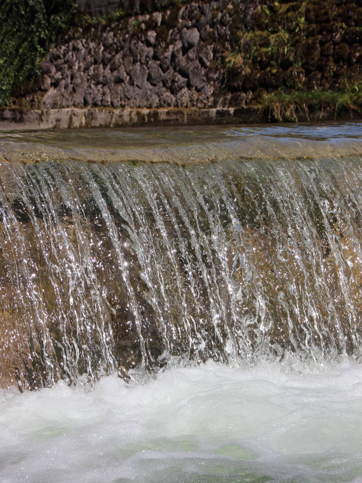 Waterfall in Drain Canal with Melting Water from Mountains