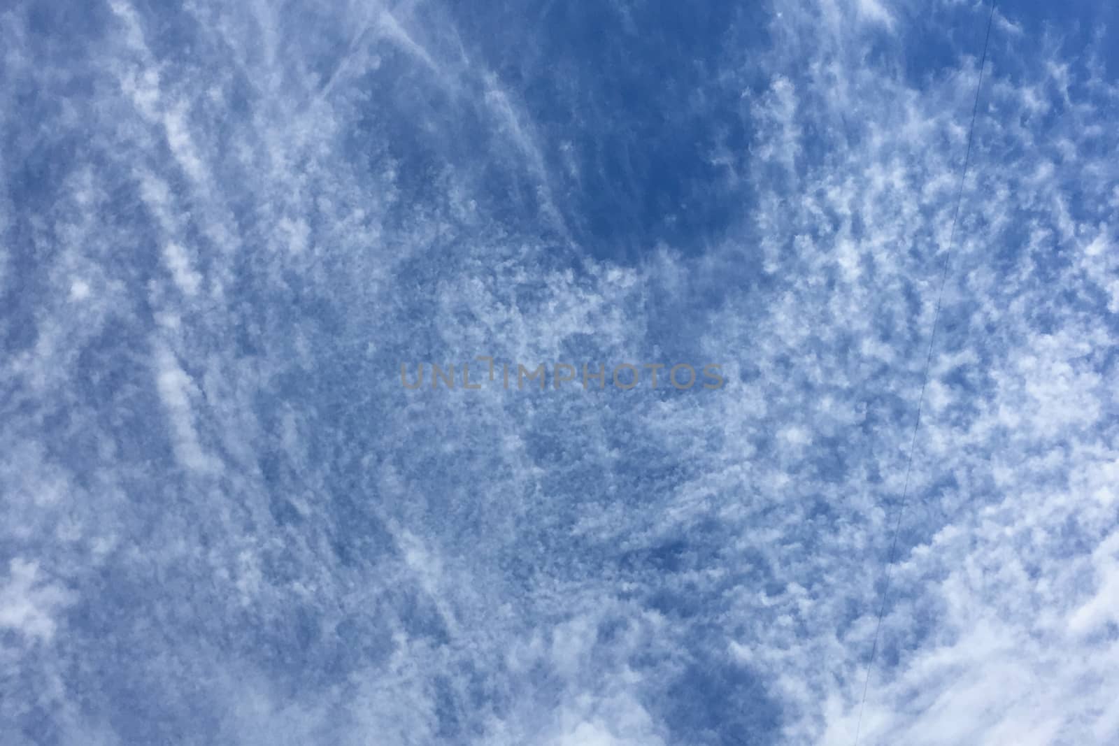 Clear blue sky with plain white cloud with space for text background