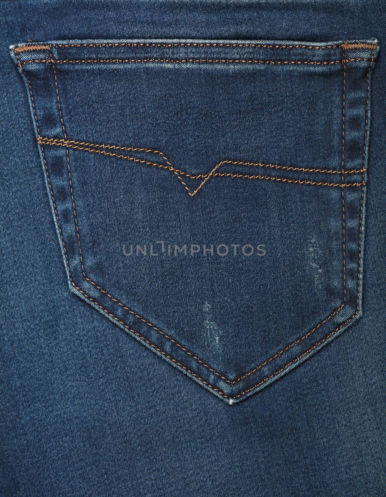 Dark indigo blue washed cotton jeans denim texture background with back pocket, close up