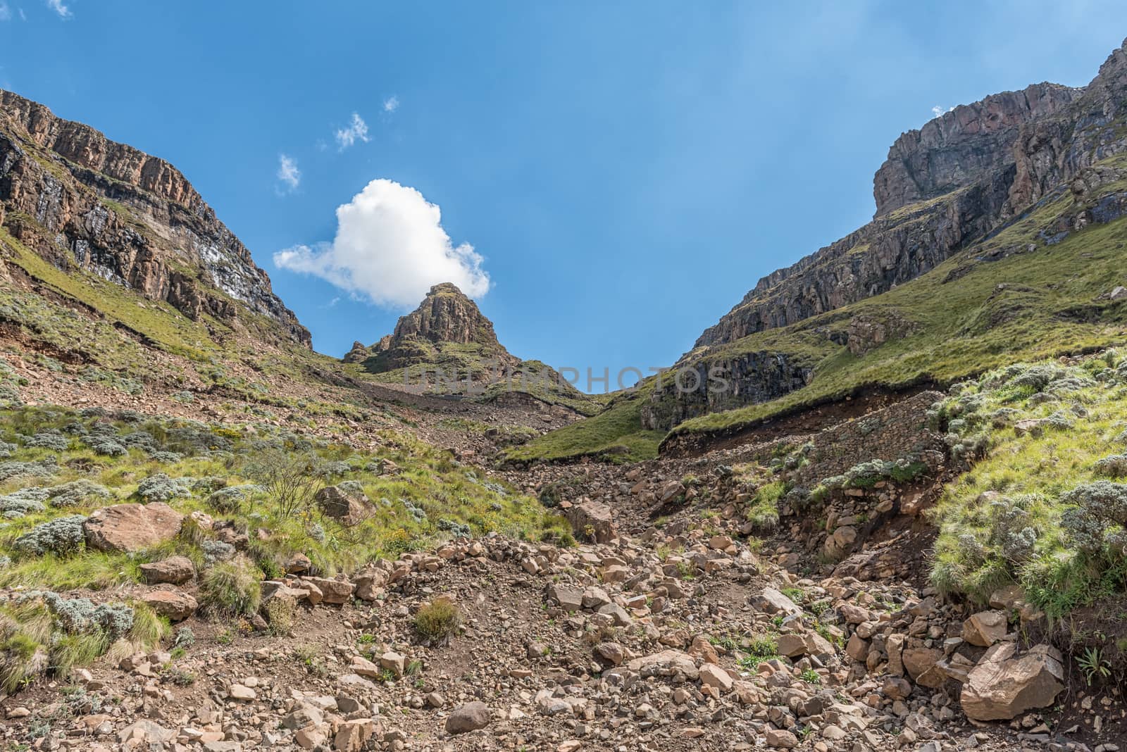 The hairpin bends in the Sani Pass. A four-wheel drive vehicle is visible in the back
