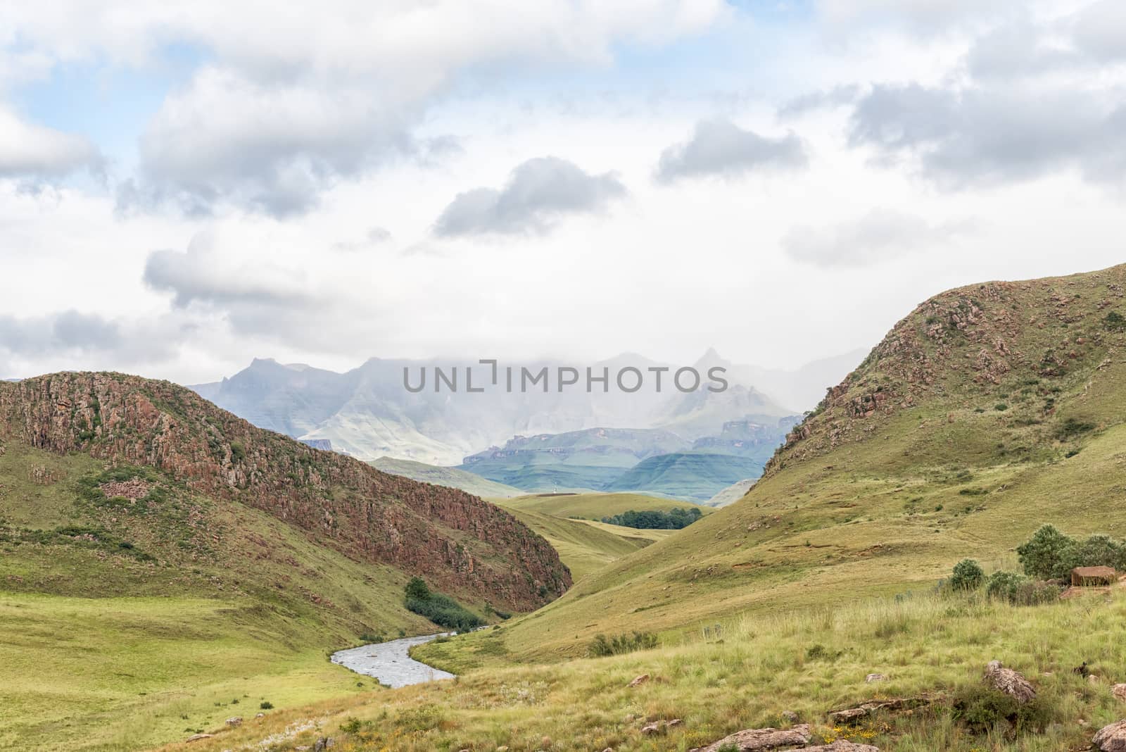 The landscape on road-P317 to Garden Castle in the Drakensberg near Underberg. Rhino Peak (3056m) is visible in the back and the Umzimkulu River in front