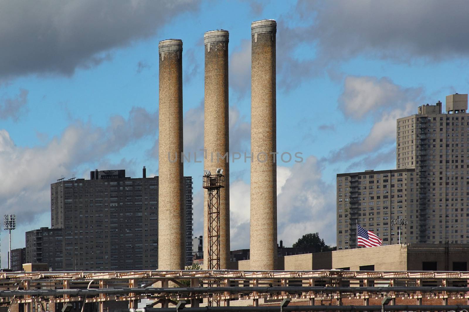 Three factory pipes on a sky background, New York City