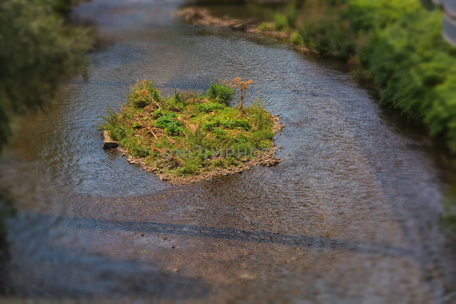 The river Wupper in Wuppertal, Germany with a small island in the river bed. Photographed from the suspension railway.