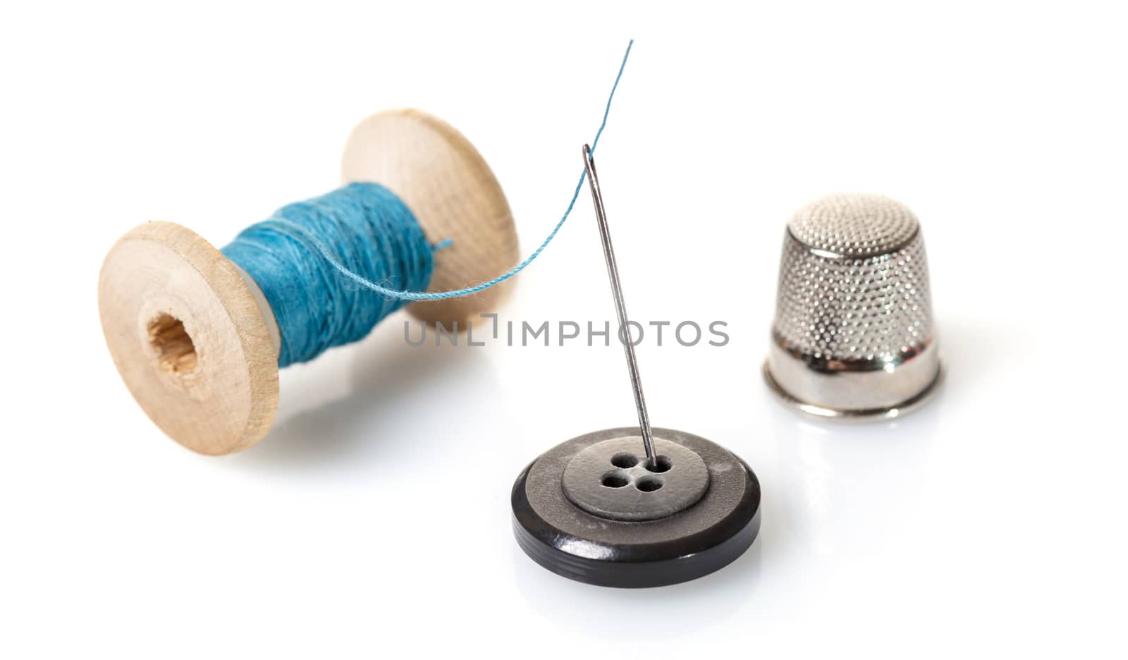 Thread with needle on white isolated background