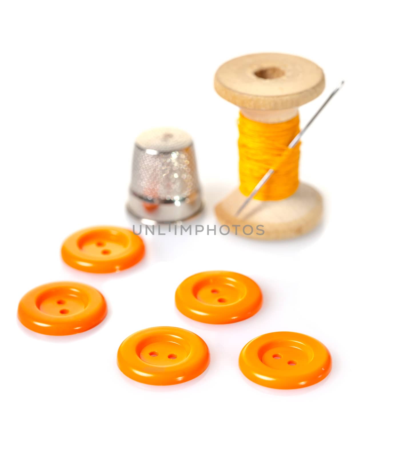 spool of thread and buttons on white isolated background