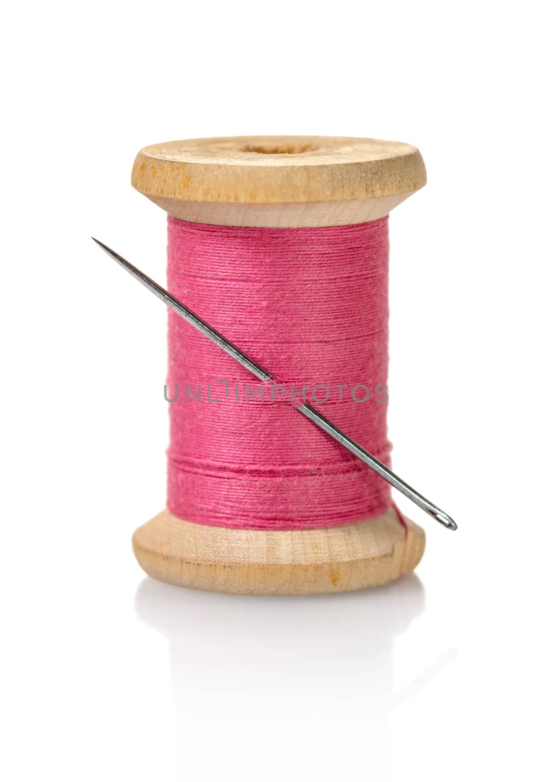 spool of pink threads on a white isolated background
