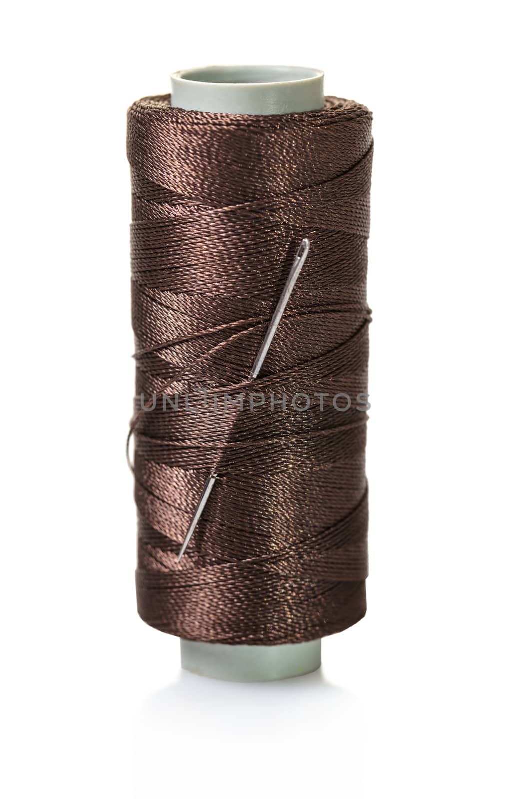 spool of brown threads on a white isolated background