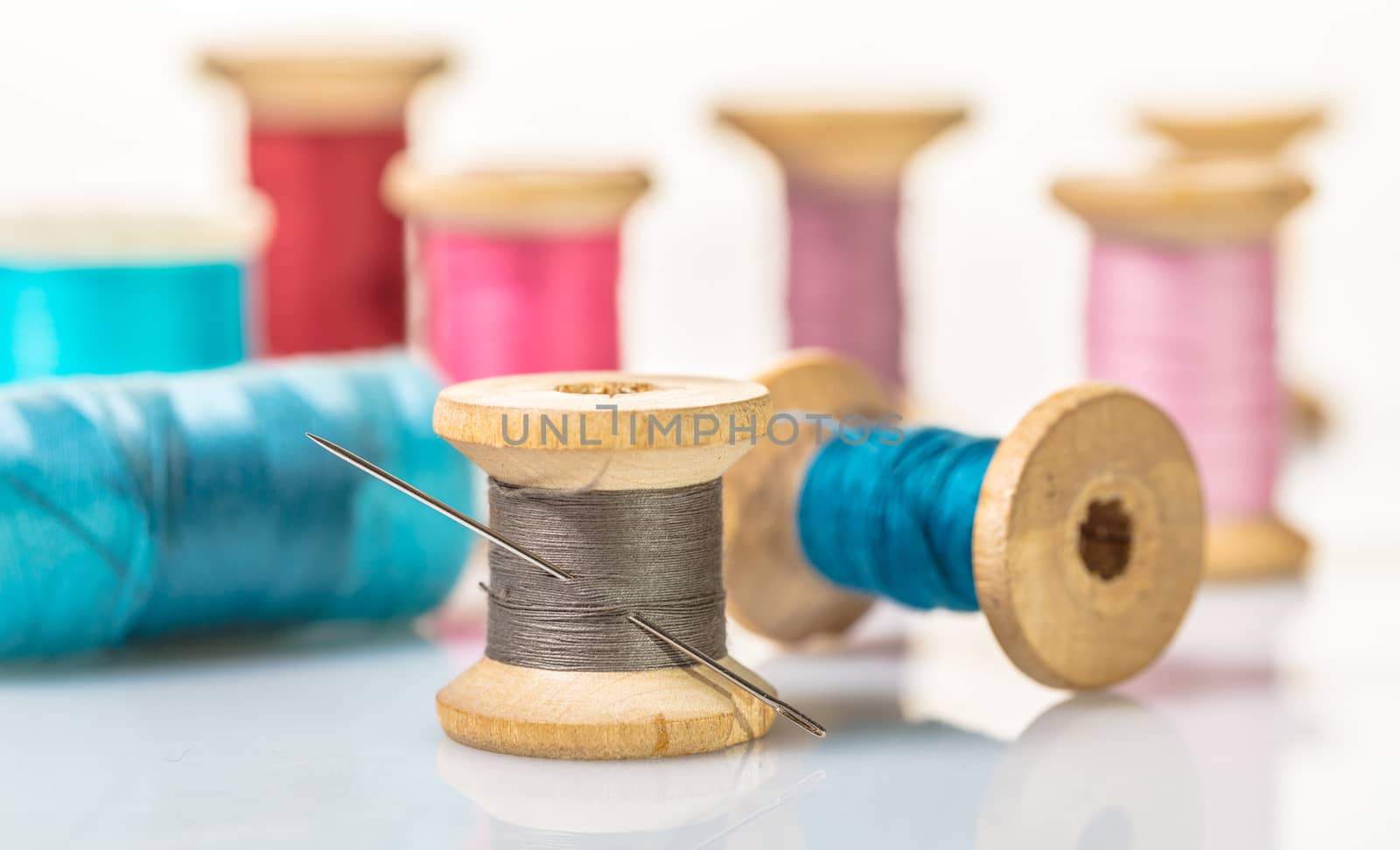 coils with colorful thread on white background