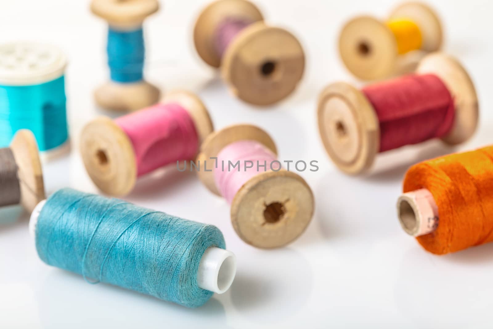 coils with colorful thread on white background