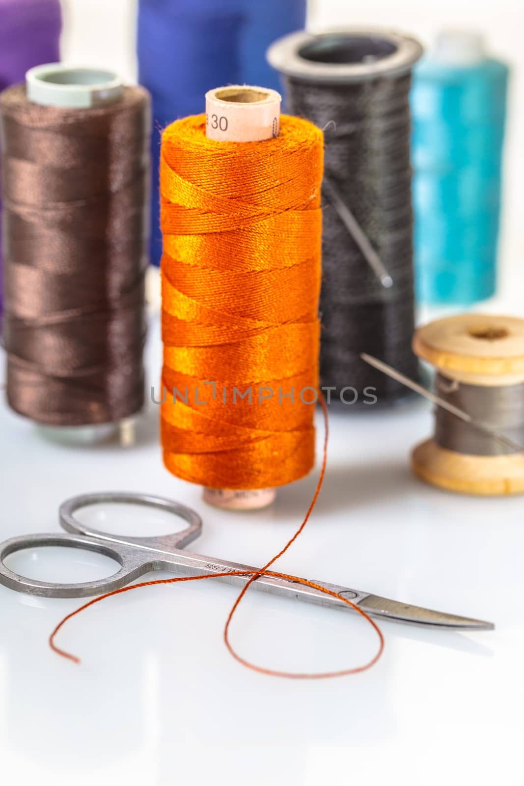 coils with colorful thread on white background