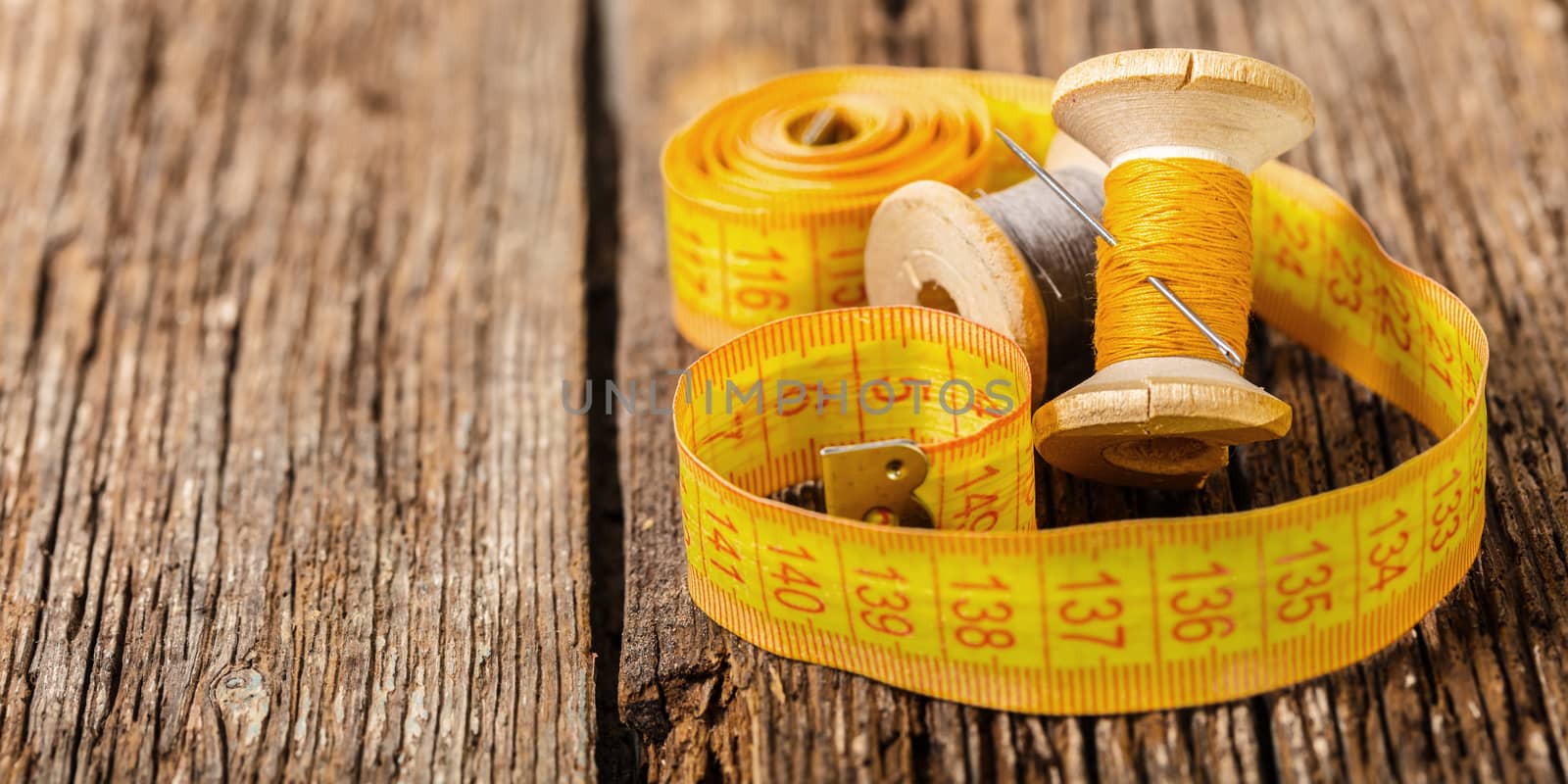 colored thread and meter on a wooden background