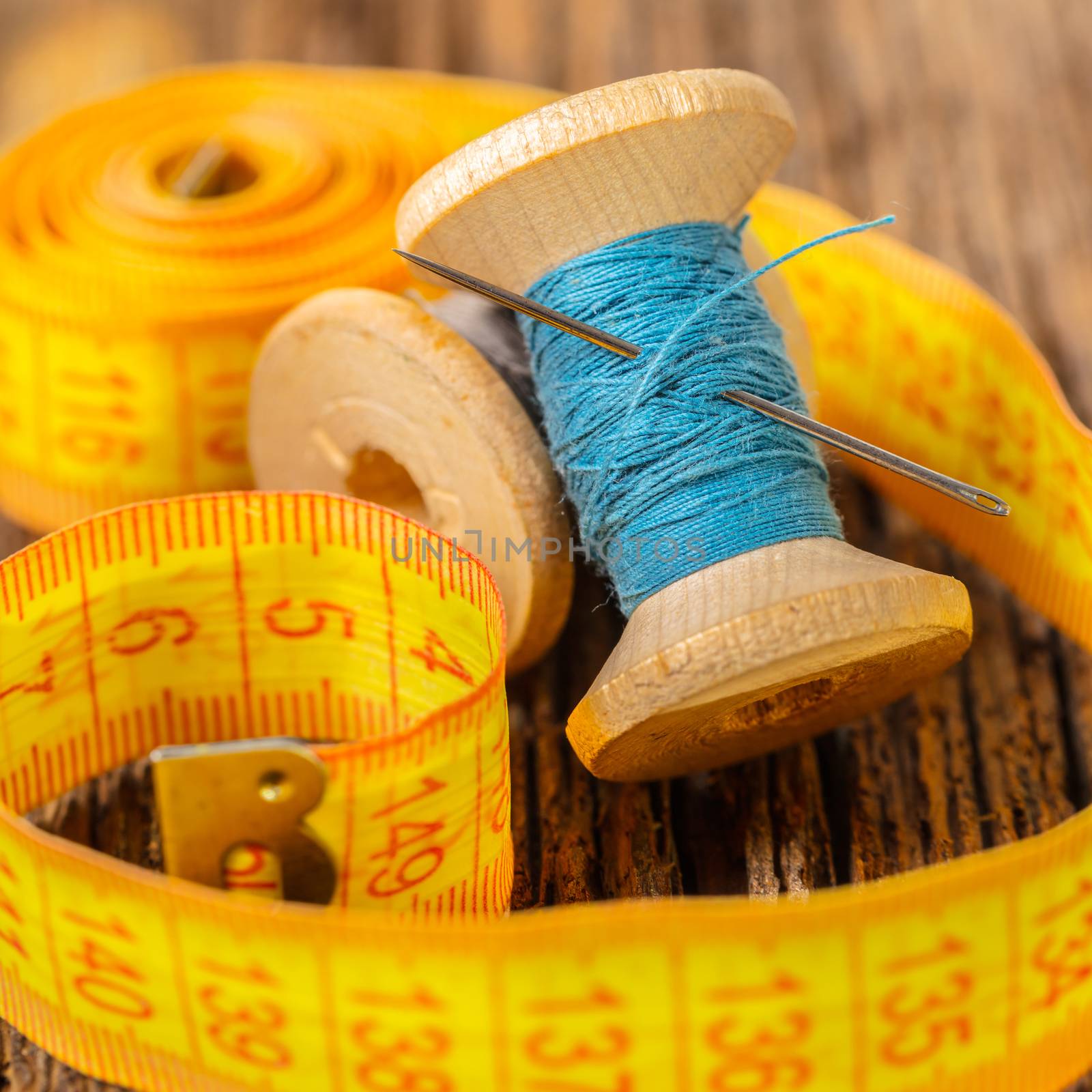 colored thread and meter on a wooden background