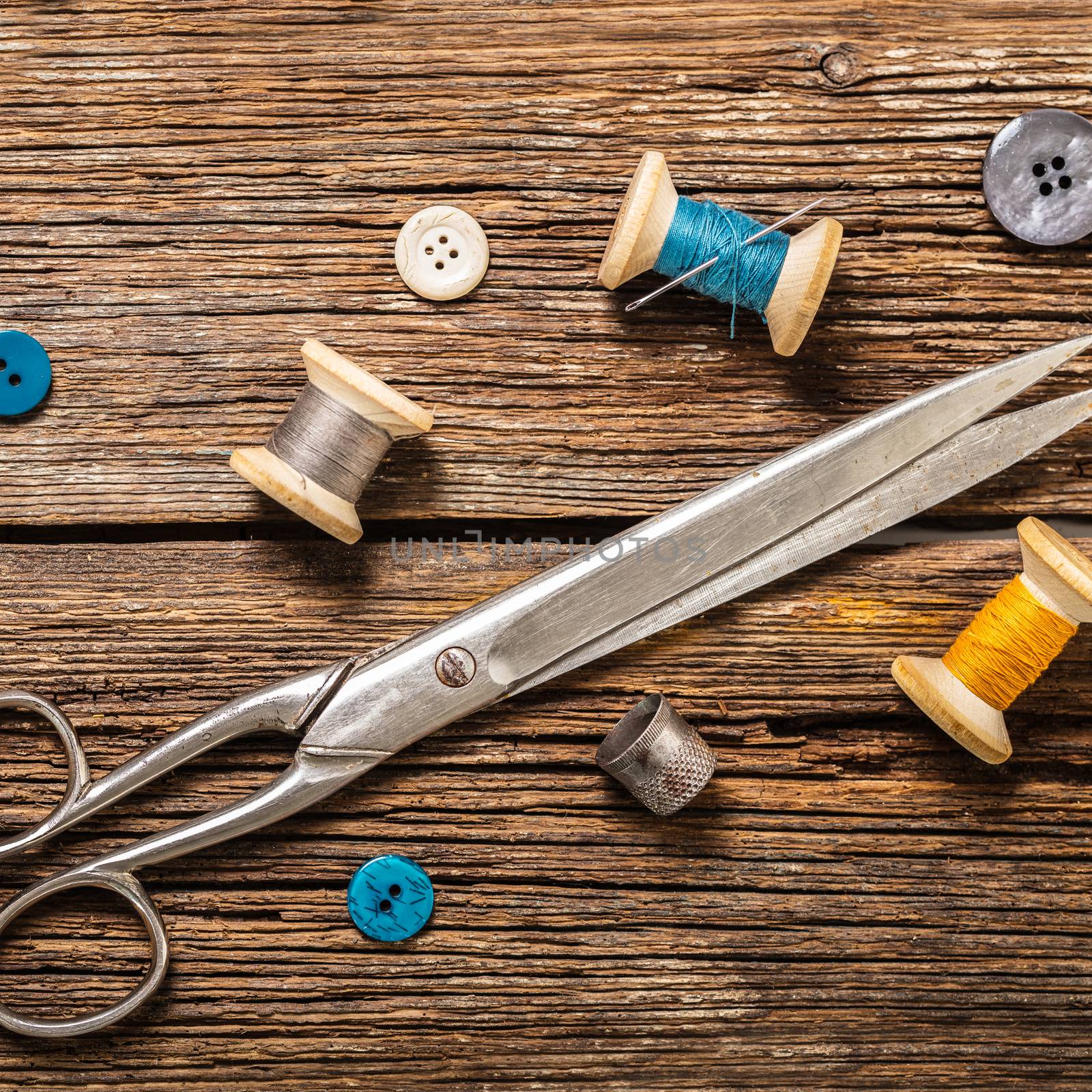 thread and sewing accessories on a wooden background