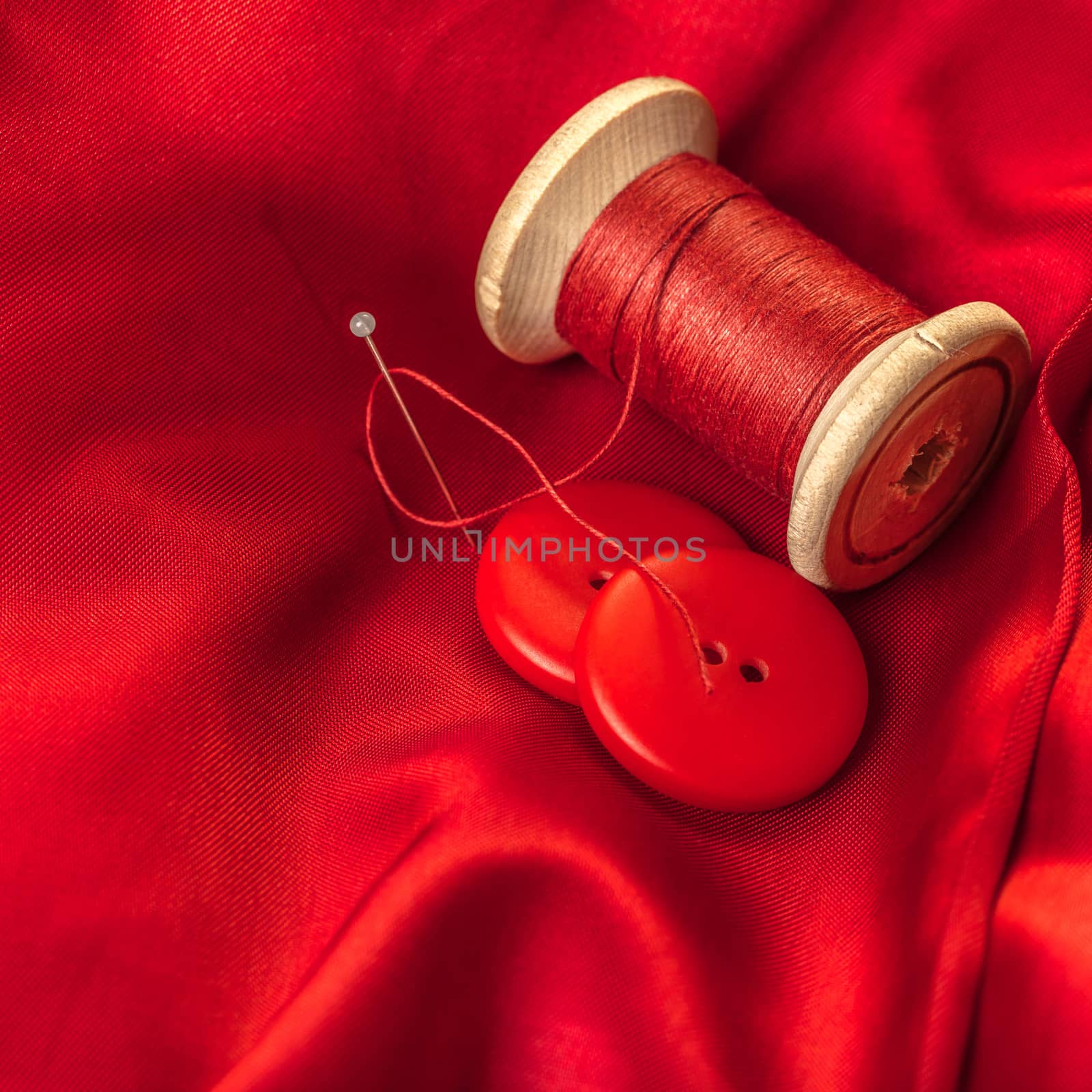 red thread with buttons on the background of lining fabric