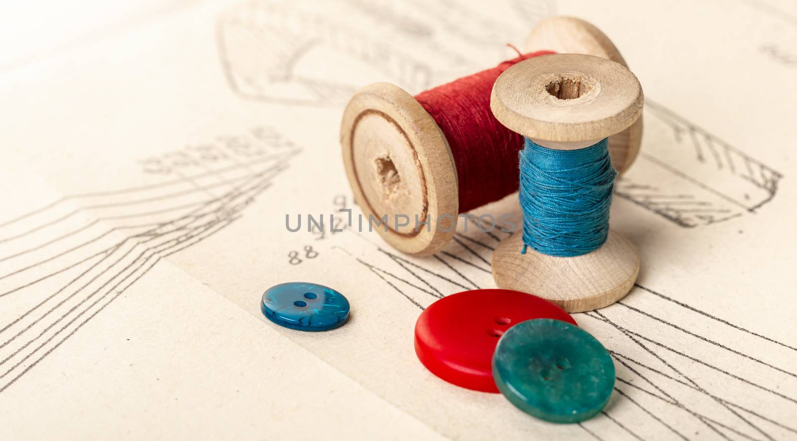 coils of colored threads on a background of paper pattern