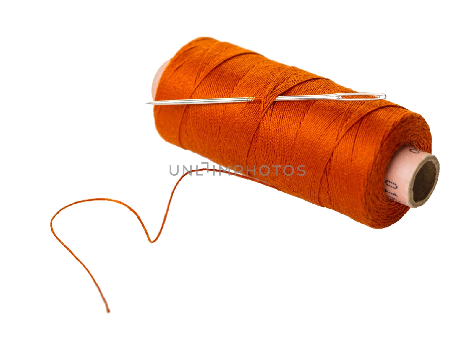 spool of thread with a needle on white isolated background