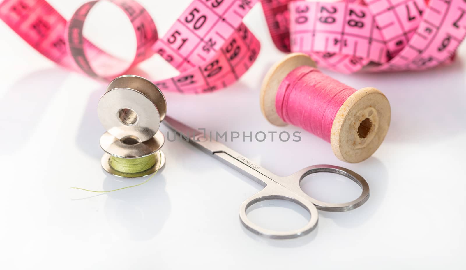 spool of pink thread and meter  by MegaArt
