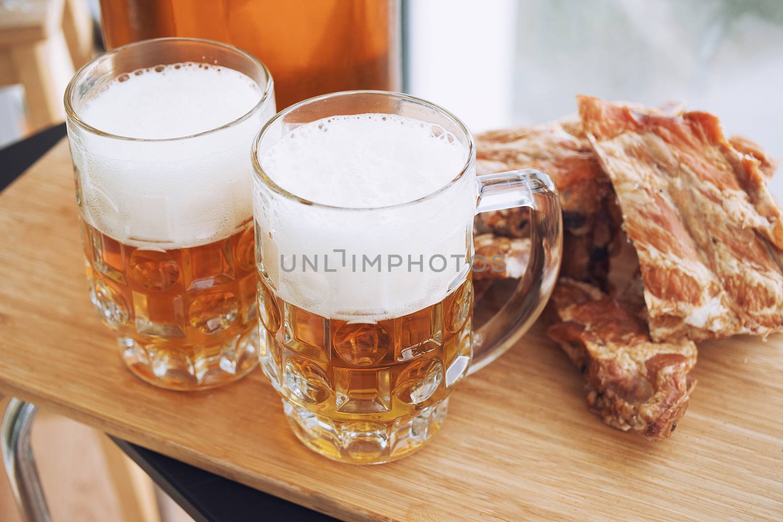 Barbecue pork ribs with beer. On wooden background.