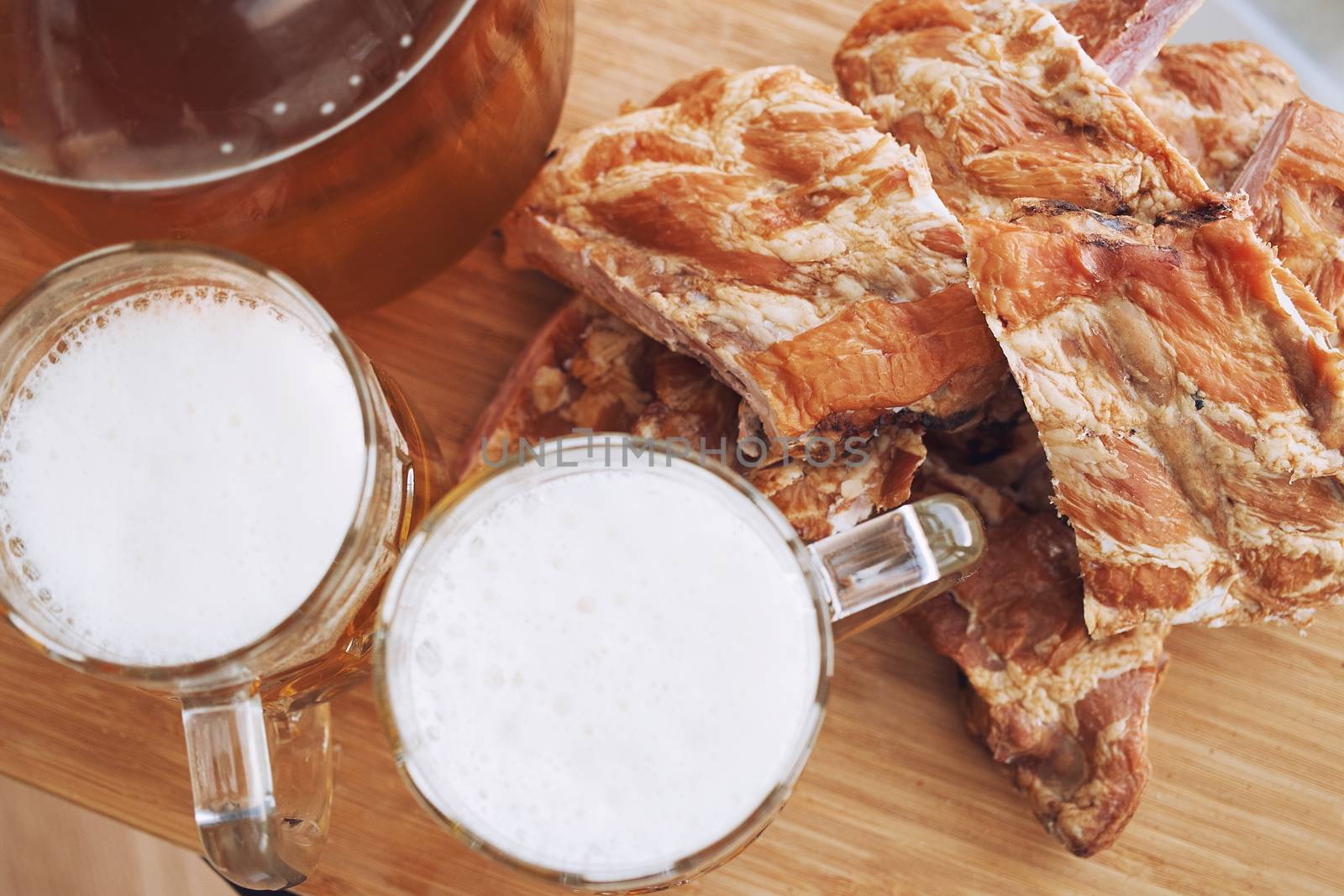 Barbecue pork ribs with beer. On wooden background.