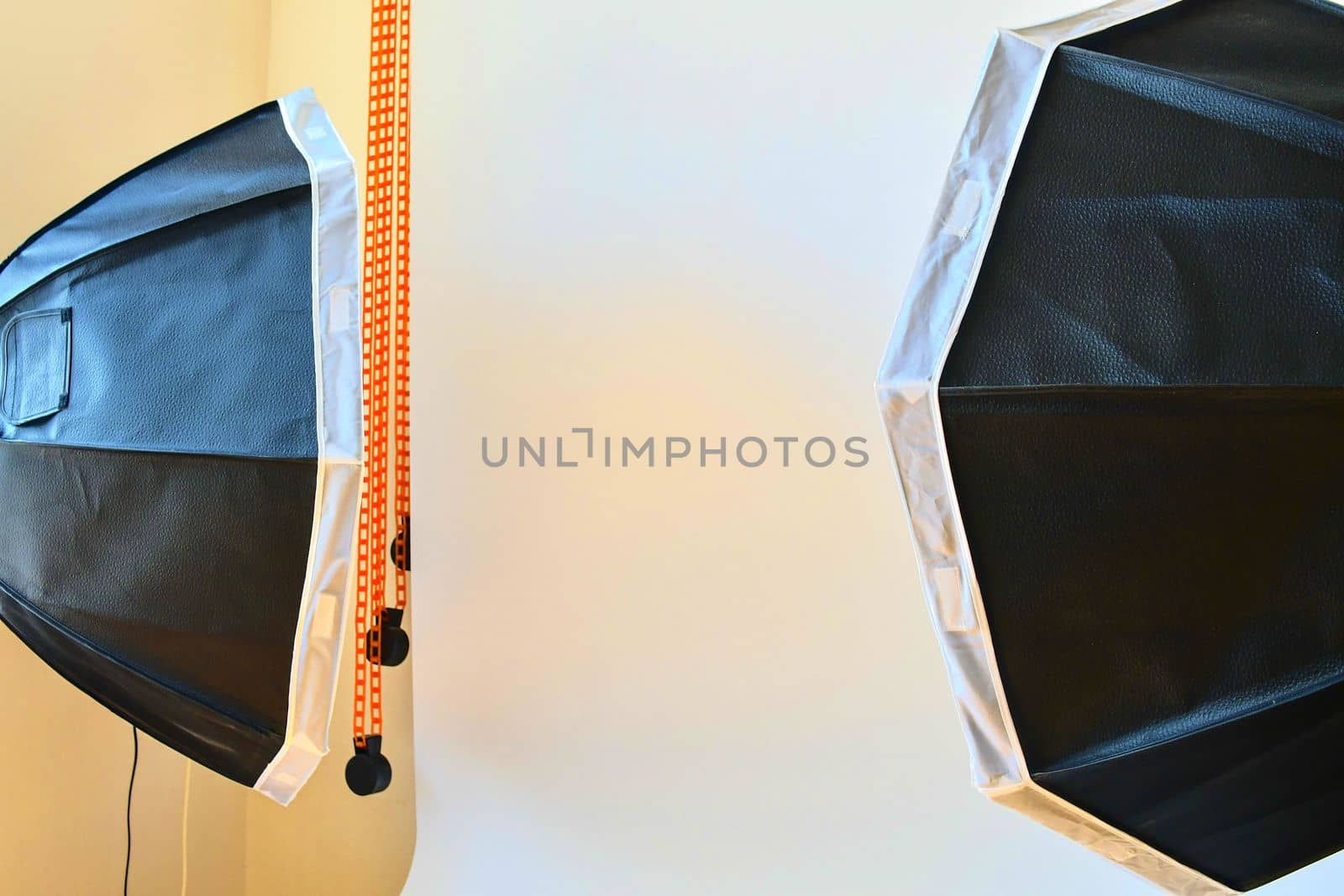 Empty photo studio with lighting equipment. White background in photo studio.