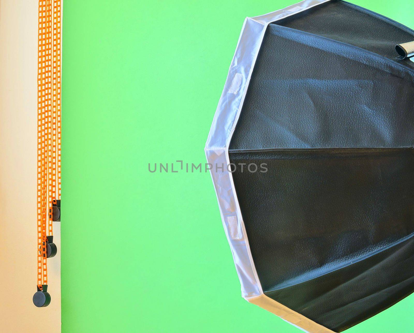 Empty photo studio with lighting equipment. Green background in photo studio by roman_nerud