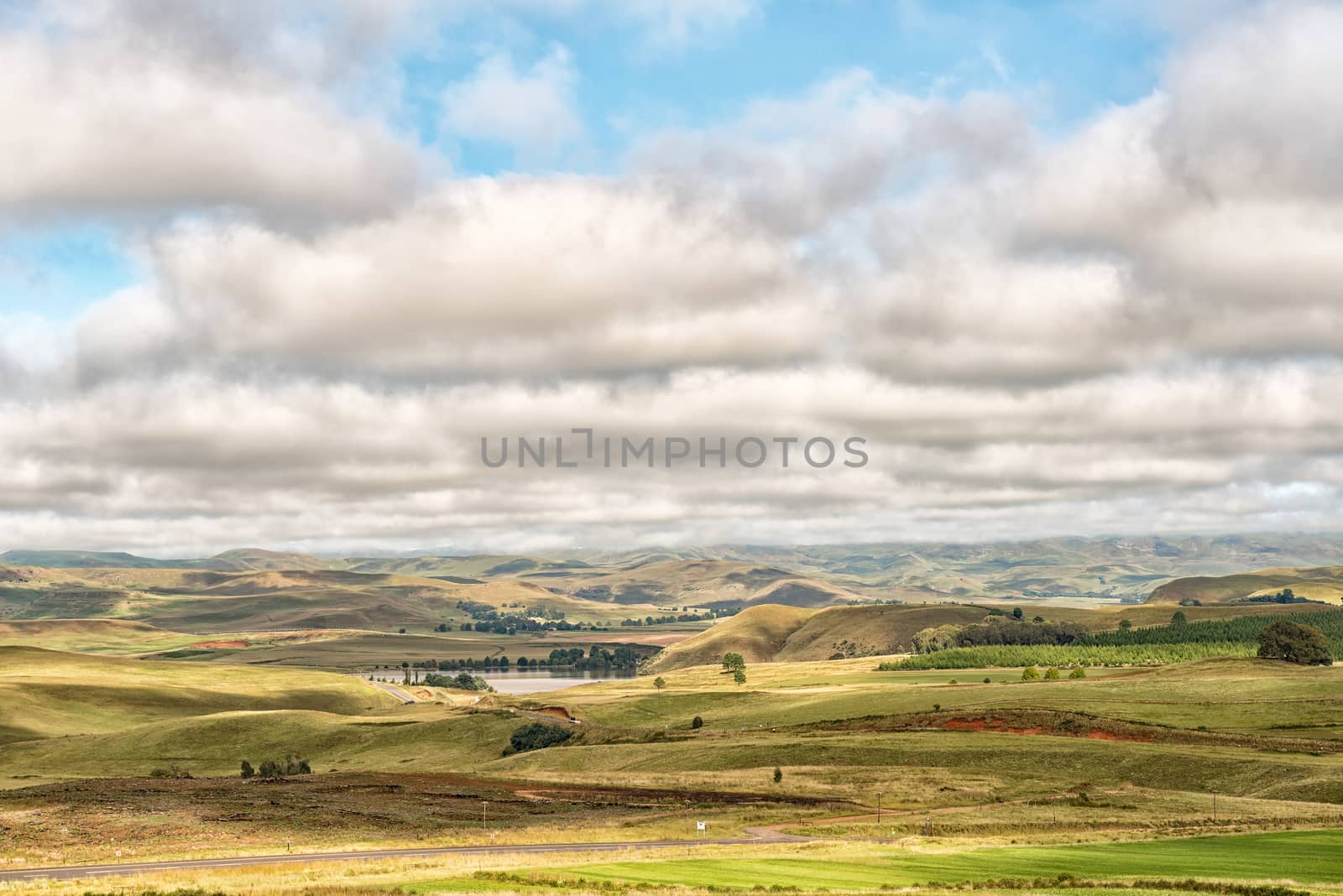 A farm landscape on the R617-road between Underberg and Kokstad in the Kwazulu-Natal Province. Lake Curragh is visible
