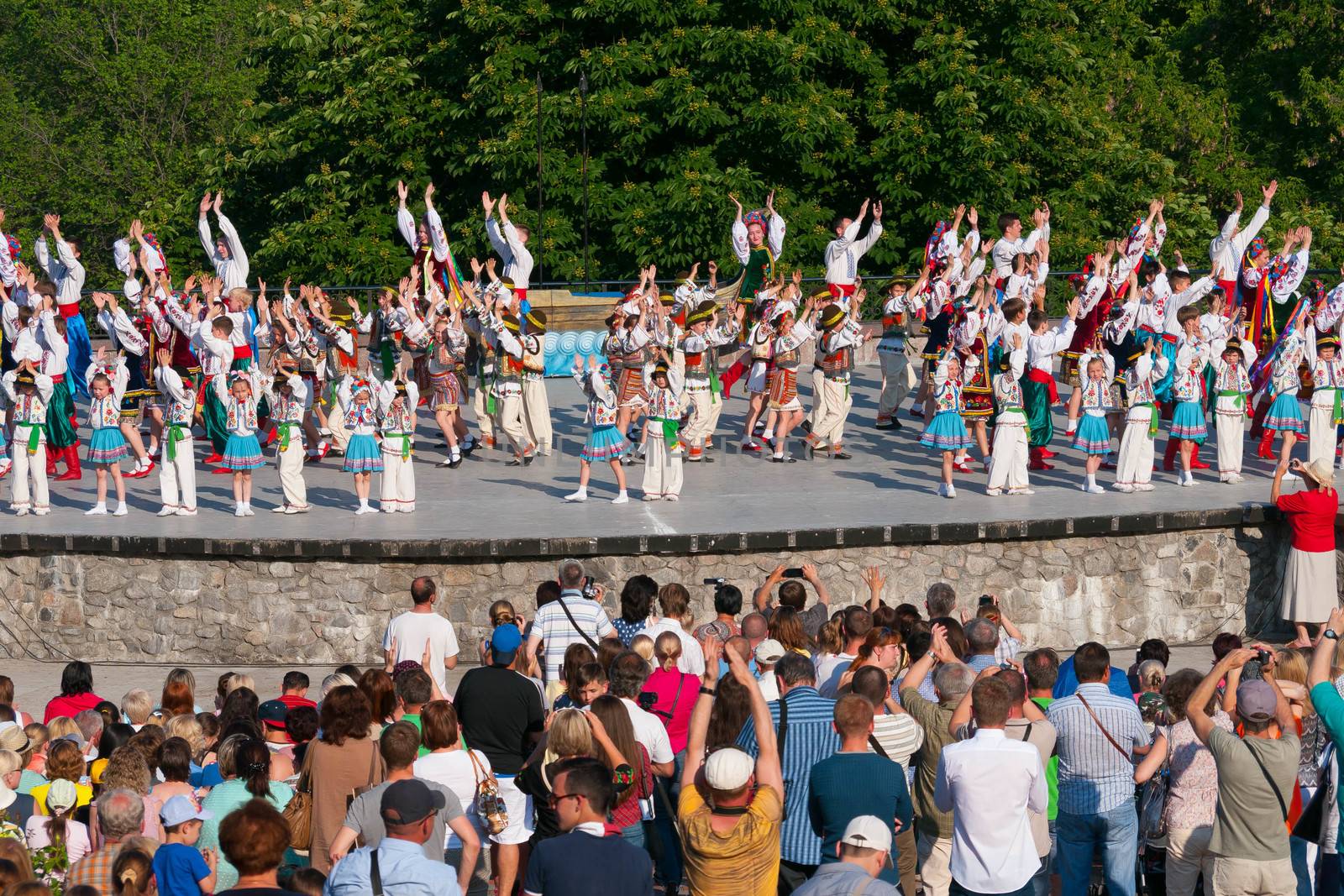 KIEV, UKRAINE - July 22 , 2016: Ukraina School of Dance Ensemble girls and boys dressed in traditional red Ukrainian embroidered costume clothes dancing